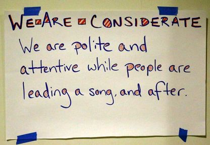 a poster with the text 'we are considerate. we are polite and attentive while people are leading a song, and after'